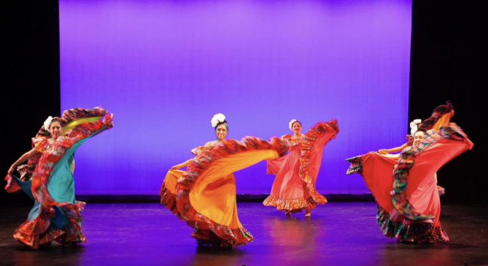 four girls performing ballet folk dance on stage